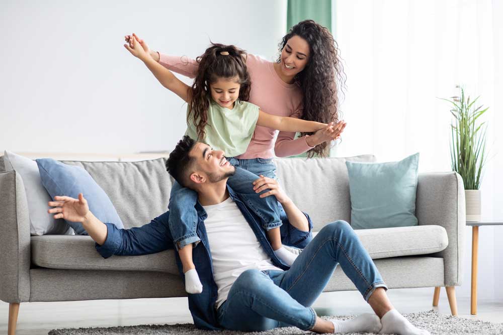 Happy family relaxing at home after service by Happy Pipes Plumbing.