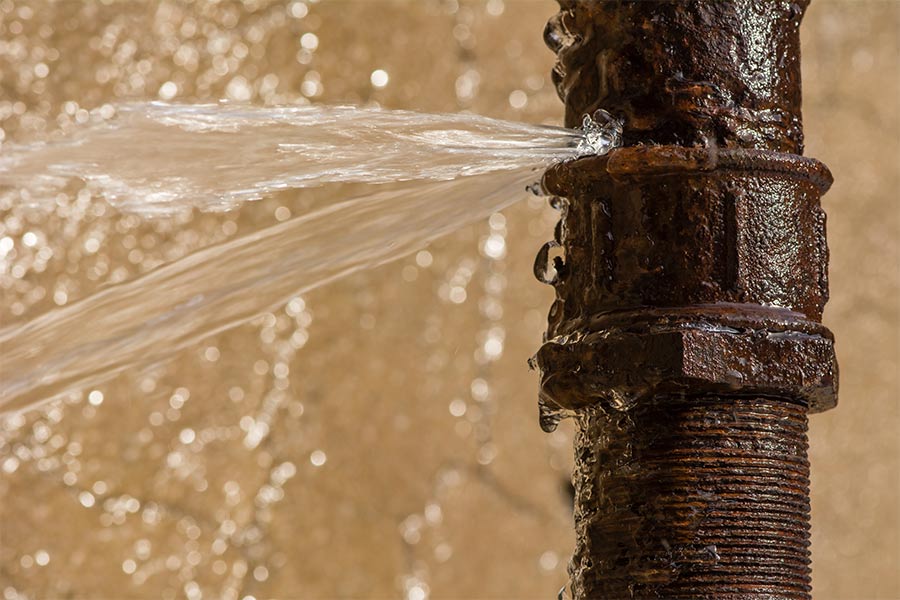 Severe leak bursting from rusty old pipe