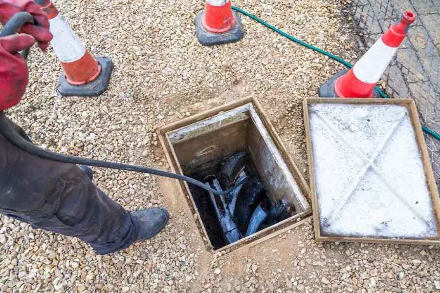 Cleaning drain line in manhole pit