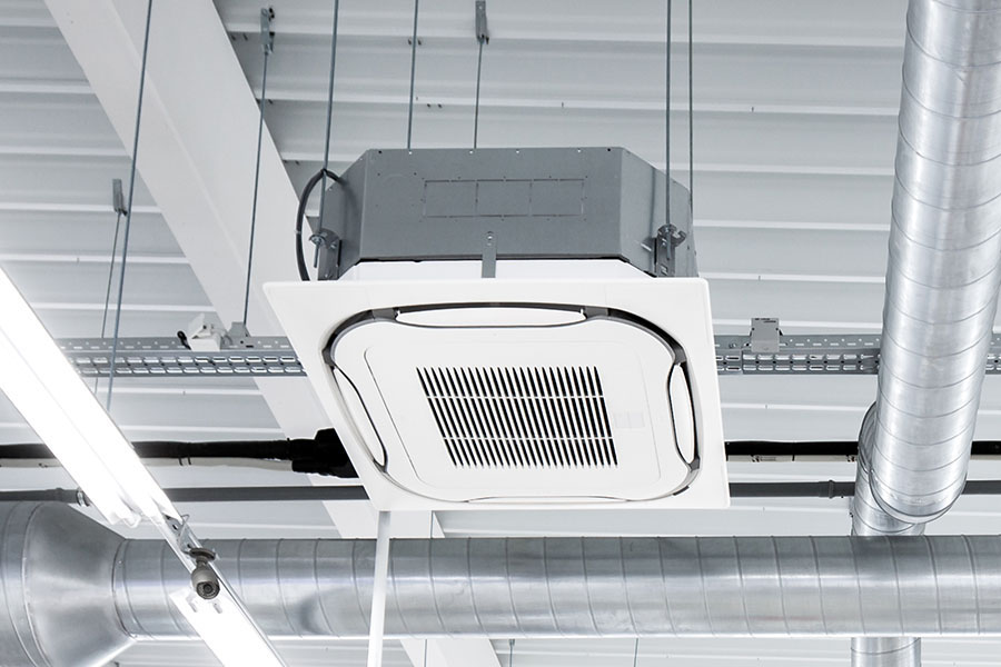 Commercial HVAC ceiling cassette air conditioner installation in building interior in Oxford MS