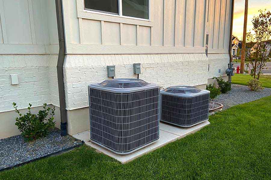 Two air conditioning units outside house