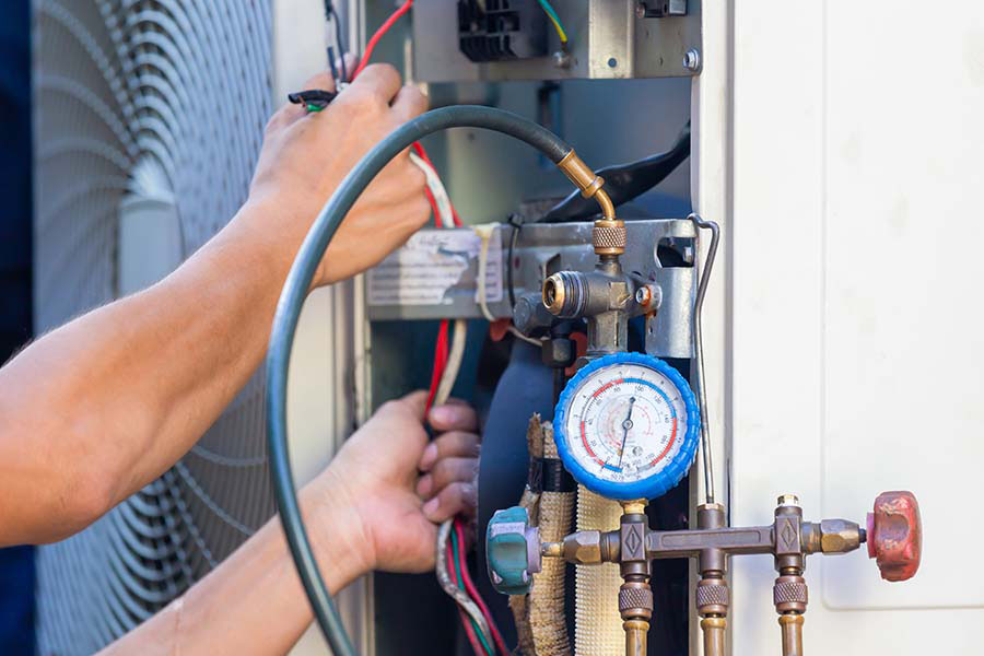 HVAC technician performing AC maintenance service in Oxford, MS