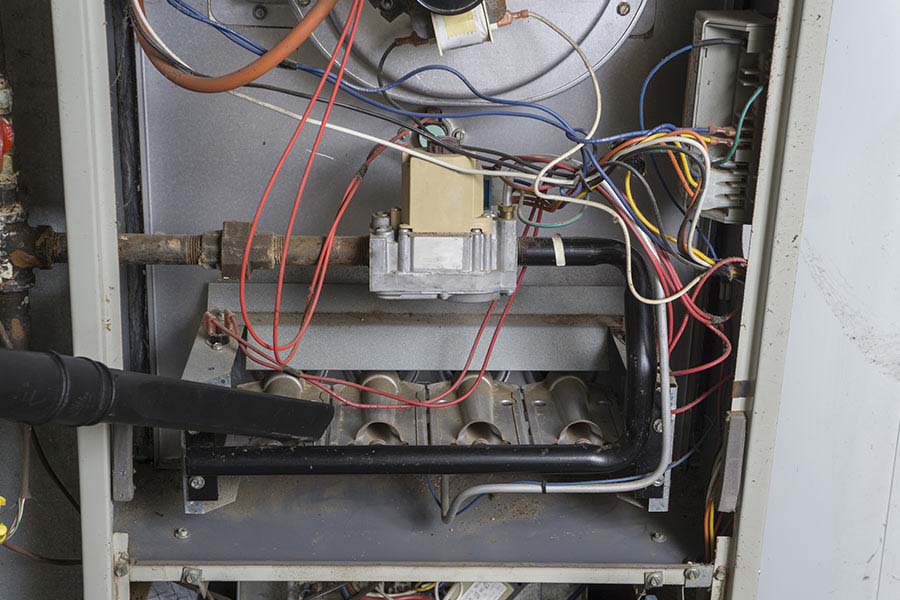 Vacuuming during furnace maintenance in Oxford